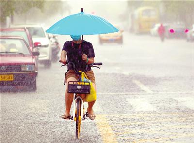 图：昨日，强降雨让外出市民猝不及防。本报记者 吴迪 摄