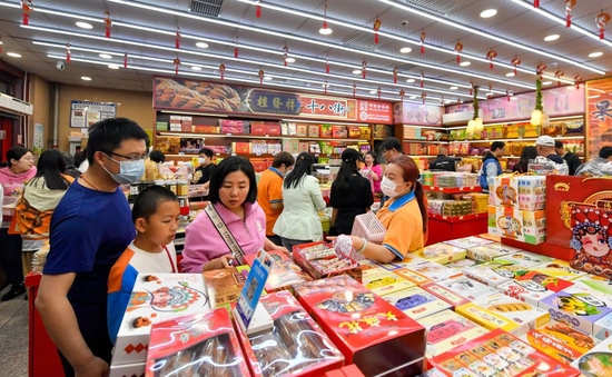↑4月29日，游客在天津古文化街一家地方特色商品店选购商品。