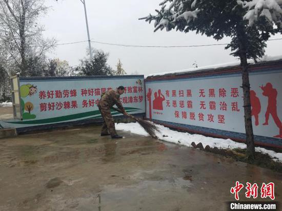 图为朱国民打扫卫生。 崔琳 摄