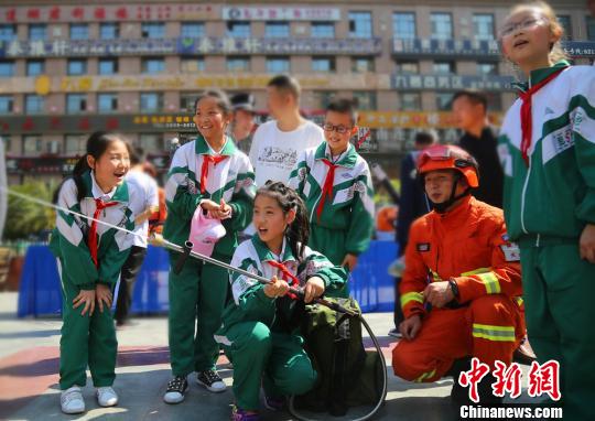 图为学生们“零距离”体验灭火装备。　王博悟 摄