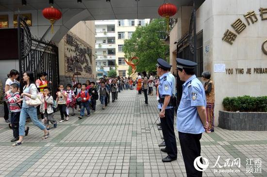 警察、辅警、安全员护送学生放学。江西3部门联合发文要求提高上放学时段校园周边的“见警率”。