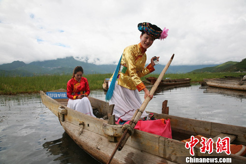生长在泸沽湖边的摩梭姑娘能歌善舞，还会划船打渔。高寒 摄