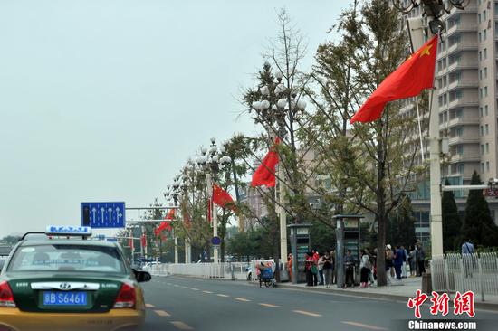 北京长安街华灯首次悬挂国旗迎国庆