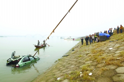 11月5日，长沙市湘江南路黑石铺大桥南事故现场，吊车将落水车辆拖向岸边。  记者 赵持 摄