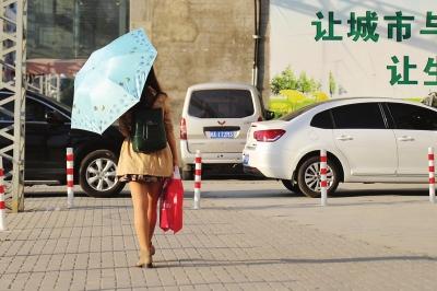 昨日气温较高,一位女士打着伞遮阳东快记者刘朔/图