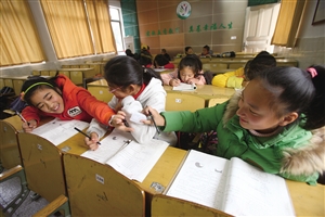 五乡镇中心小学,一些学生在多媒体教室里写作业,等待家长来接