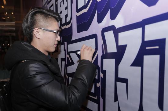 全城大V名人在签名墙上签字。
