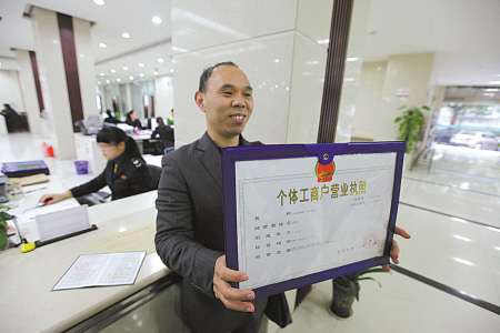 刘先生领取首本“多合一”营业执照。(胡建华 摄)