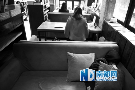 12月12日上午,不打烊书店里,12岁的杨东吃完午饭后抱着抱枕蜷在沙发里睡觉。