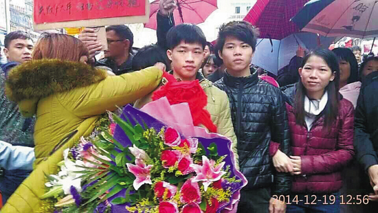 妈妈为庄国星戴红花,迎接他回家(受访者供图)