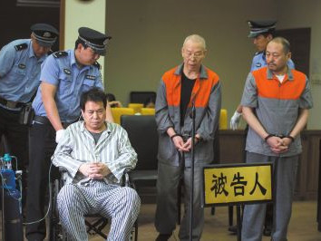 去年5月19日,被告李万勇坐轮椅、携氧气瓶出庭受审。