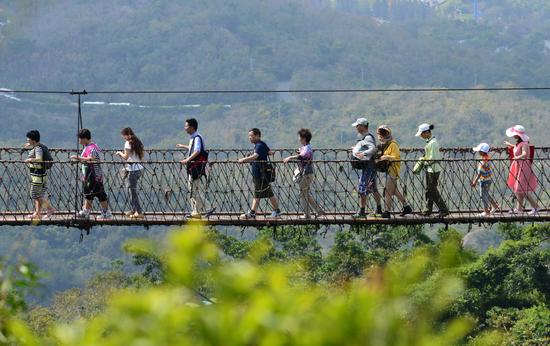 中外游客春游亚龙湾热带天堂森林旅游区。(黄庆优摄)