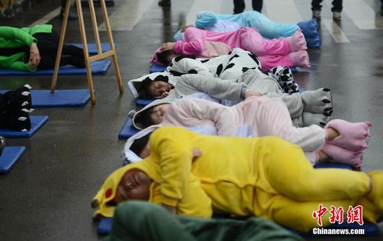 3月20日，世界睡眠日前夕，被誉为中国“睡眠先生”的唐堂带领众多市民来到长沙街头进行“睡大街”公益行为艺术展示。 杨华峰 摄