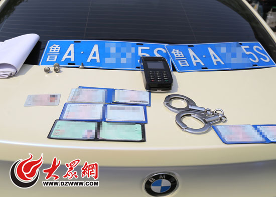 交警在寶馬車內搜出手銬、POS機、多本行駛證、借款合同等物品。