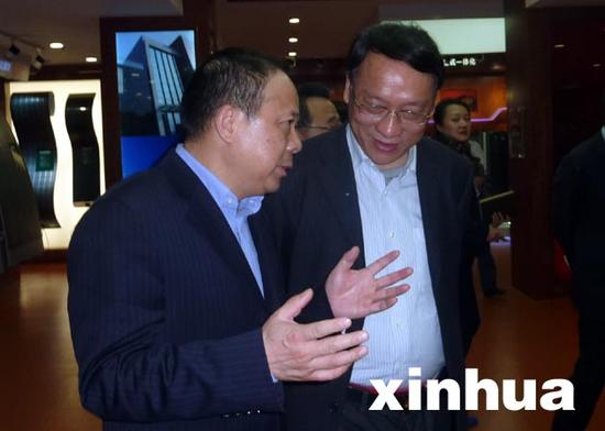 武汉市人民政府市长万勇(左)向新华社高级记者方政军博士介绍项目合作情况。