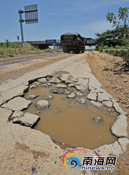 海屯高速匝道口边上的公路，已被来往的超载运砂车碾压得伤痕累累。南国都市报记者刘孙谋摄