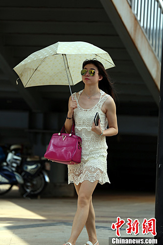 6月25日，江西省会南昌街头，许多女性市民衣着清凉，吸引眼球。姜涛 摄