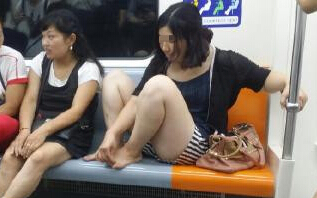 一名女子在地铁上旁若无人的抠脚