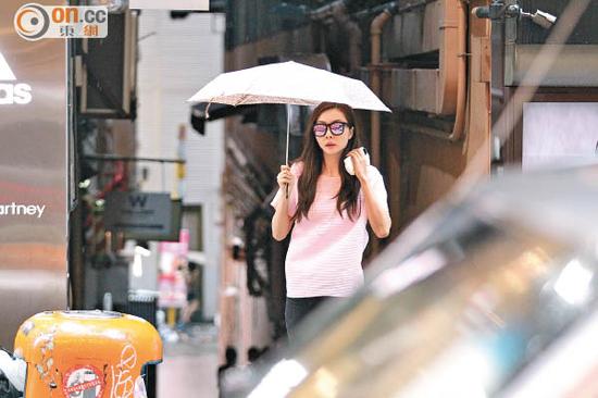 熊黛林打着伞下车。