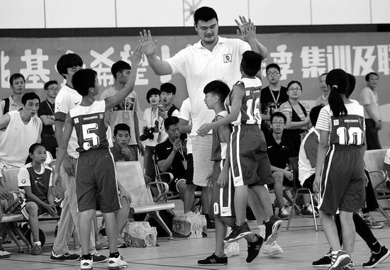 小队员跳起来与姚明击掌 本报记者马昭摄