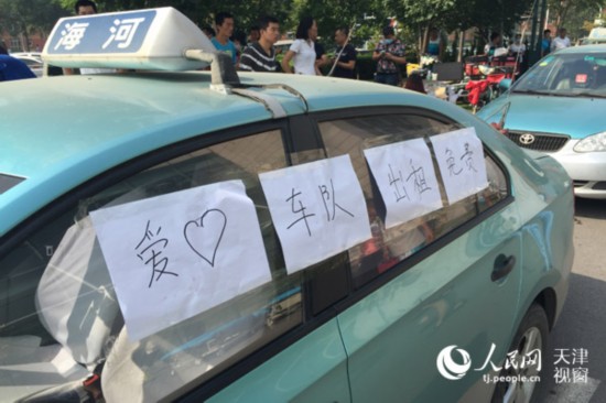 车身粘贴有“爱心车队出租免费”的爱心车队(摄影:孙晓川)