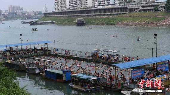 8月20日是民间传统的七夕节，广西梧州市民有下河戏水的习俗，该市体育局在流经境内的桂江河上设置的3个河上移动游泳池人头涌涌。