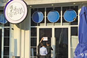 昨天下午,餐厅工作人员在张贴“暂停营业”的通知。