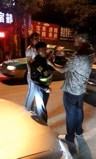 事发现场,协警被两人夹在中间。