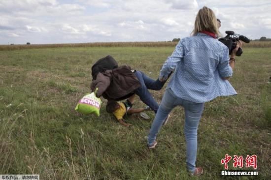 一名女摄像师，在抱着孩子的难民逃过身边的时候，显然易见地故意将其绊倒，难民措手不及，抱着孩子重重地摔在地上