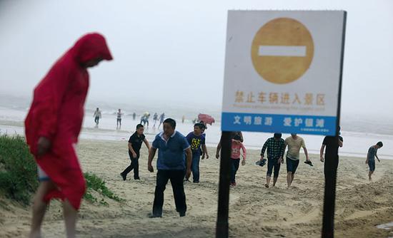 台风彩虹翻搅北部湾 游客不顾危险专程来玩风