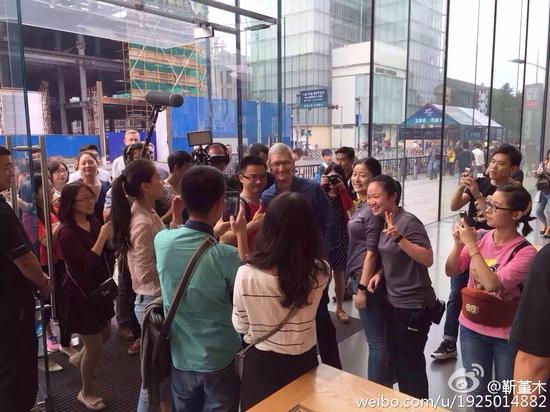 库克在杭州苹果西湖店于消费者合影(图片来源于微博)