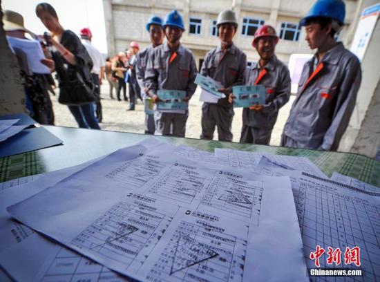 资料图:建筑用工企业展示为农民工发放工资的银行小票及缴纳工伤保险的复印件。
