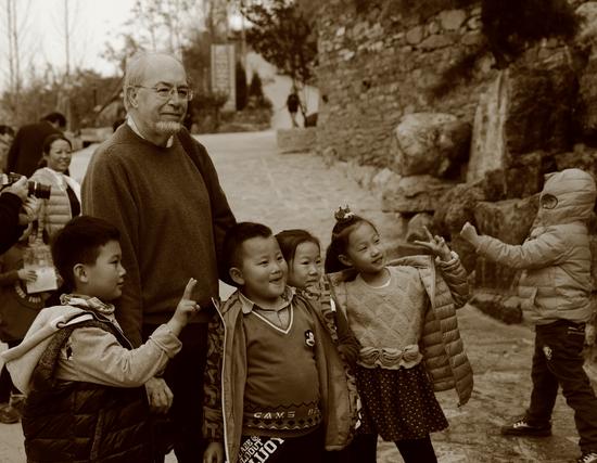 法国摄影家联盟成员，法国IBM全国摄影家协会主席阿兰•勒莫(Alain  Reumaux)在上端士村与孩子们在一起