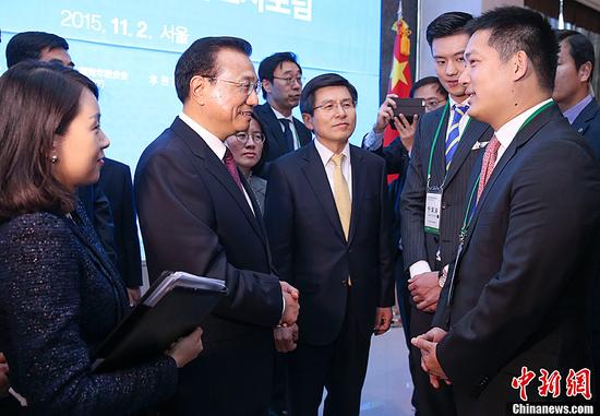 这是两国总理会见青年代表时，李克强与常昊和宁泽涛交谈。中新社记者 刘震 摄