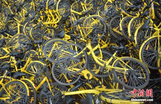 资料图：成都一停车场内堆放了不少共享单车，大多数车锁已被拆除，这些单车系临时回收、维修中转车辆。中新社记者 刘忠俊 摄