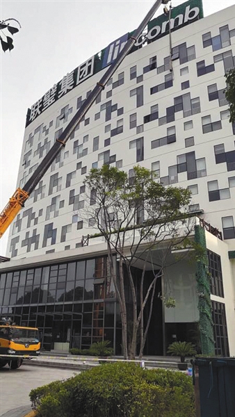 6月下旬，上海联璧集团总部，施工人员正拆除楼顶招牌。受访者供图