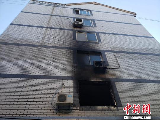 发生爆燃的单元楼侧面，2楼的门窗和3楼外挂空调被烧毁。　徐巧明 摄