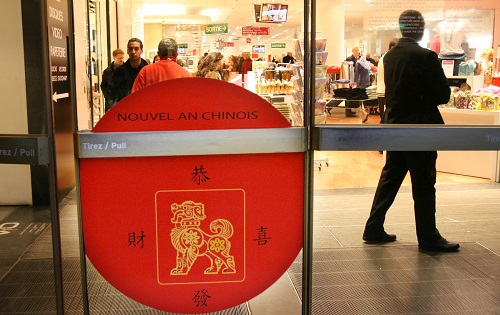 资料图：2006年2月1日，法国巴黎老佛爷百货公司门上的一块牌子写着“恭喜发财”字样，庆祝中国春节的到来。 新华社记者宋立东摄