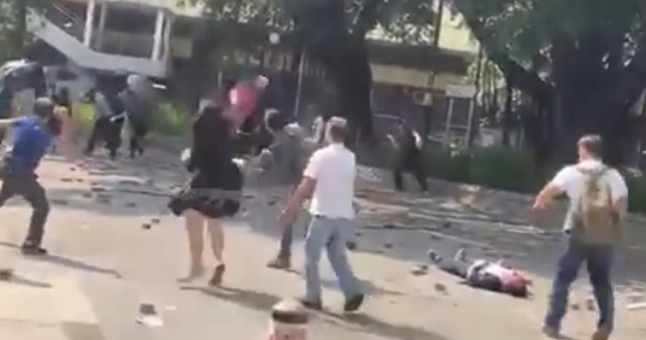市民与黑衣人对峙,男子被硬物砸中(明报)