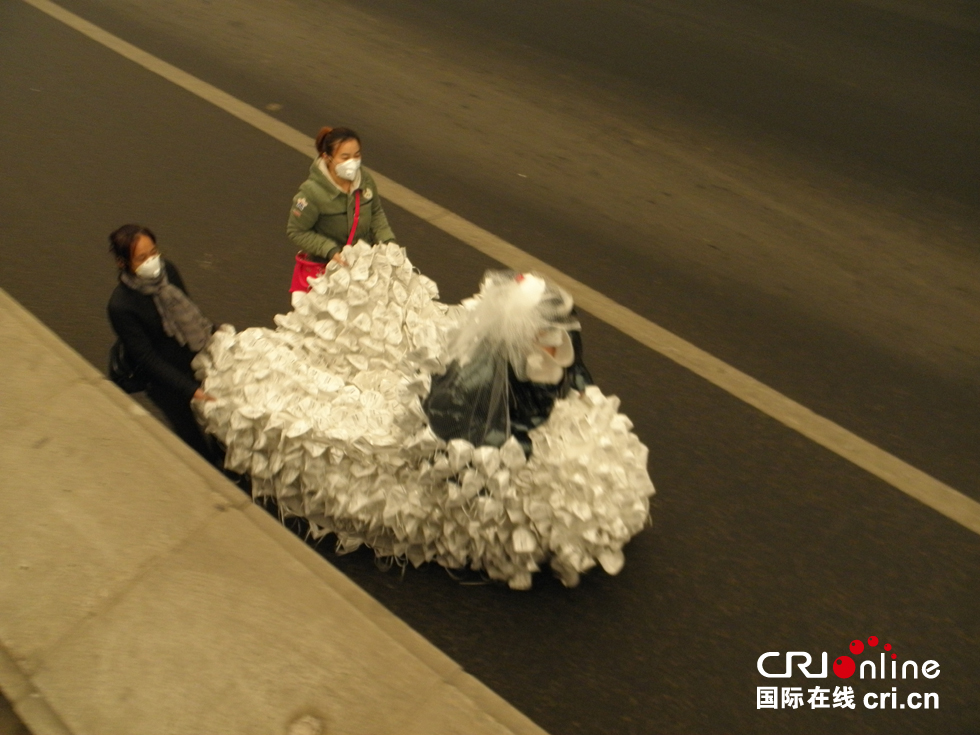 艺术家穿口罩婚纱亮相北京雾霾天 呼吁绿色出