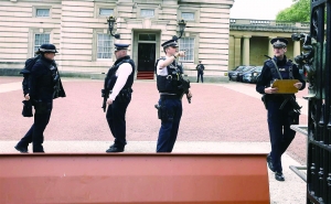 英国王宫白金汉宫大门附近，警察全副武装巡逻。