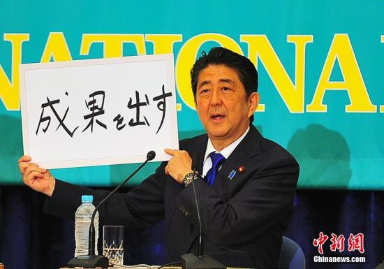 日本首相安倍在2016年的党首辩论会上亮出“搞出成果”字牌。中新社记者 王健 摄