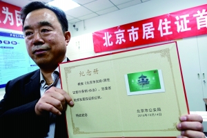 昨天下午，在东城公安分局前门派出所，吴伟贤领到本市首张居住证。 警方供图
