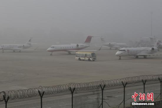 11月5日早晨，北京大雾弥漫，部分地区出现能见度不足200米的强浓雾。同时中到重度霾持续。北京市气象台11月4日晚21时发布大雾橙色预警信号，预计至11月5日早晨本市大部分地区有能见度小于200米的浓雾，局地能见度小于50米。图为北京首都机场笼罩在雾霾之中。中新社记者 李慧思 摄
