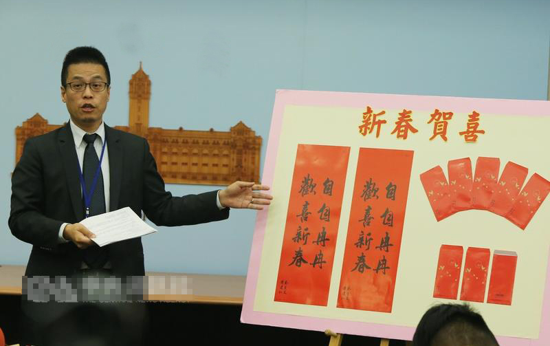  黄重谚昨日介绍蔡英文上台后，台湾地区领导人办公室发布的首款贺岁春联及红包袋。（图片来源：台湾“中央社”）