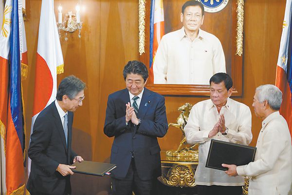 安倍(左二)与杜特尔特(右二)12日出席签约仪式。