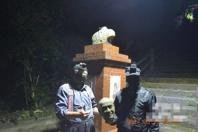 两名蒙面男子在台北市内湖区斩首蒋介石铜像照。（图片来源：中评社）
