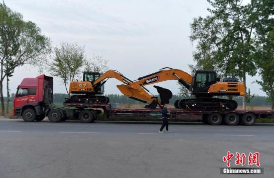 镜头记录雄安新区街头即景。大型工程车经过雄安新区白洋淀附近的公路。 中新社记者 翟羽佳 摄