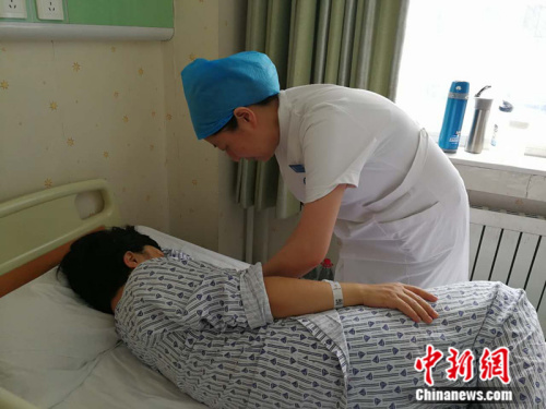 孙敏在床旁指导产妇给新生儿喂奶 <a target=\'_blank\' href=\'http://www.chinanews.com/\' >中新网</a>记者 张尼 摄