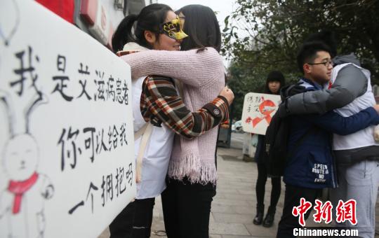 资料图:志愿者们与行人拥抱。 曹正平 摄
